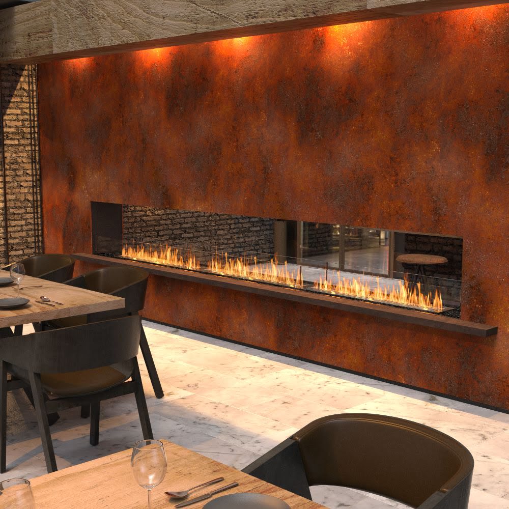 Modern restaurant interior with a long, linear fireplace and wooden tables.