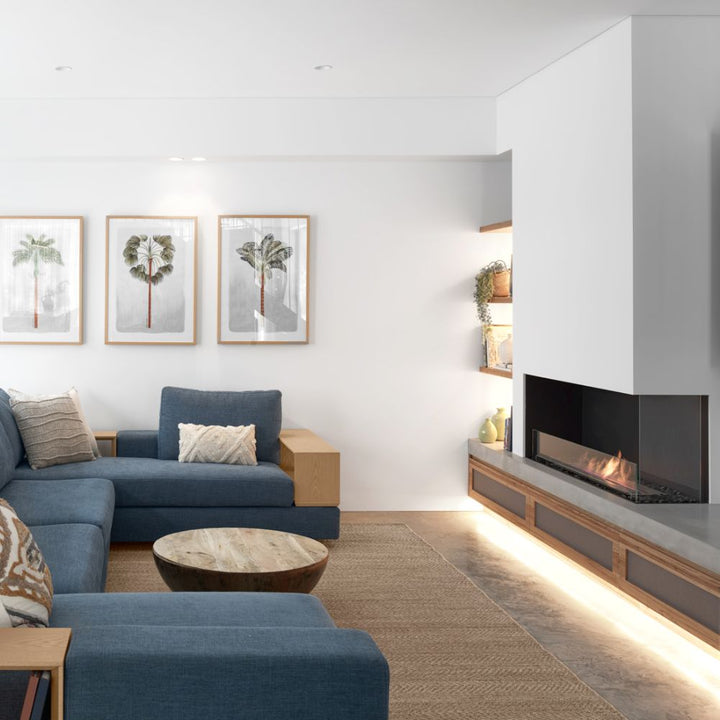 Flex 18RC Modern living room with blue sofa, wooden coffee table, and fireplace.